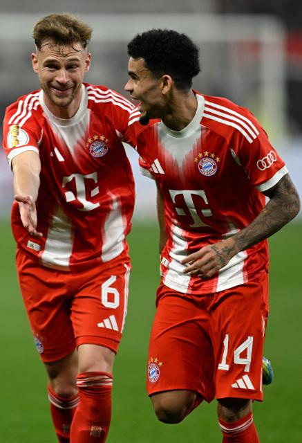Bayern Munich's Colombian forward #14 Luis Diaz celebrates scoring the 0-2 goal with his teammate Bayern Munich's German midfielder #06 Joshua Kimmich during the German Cup (DFB-Pokal) semi-final football match between Bayer 04 Leverkusen and FC Bayern Munich in Leverkusen, western Germany on April 22, 2026. (Photo by INA FASSBENDER / AFP) / DFB REGULATIONS PROHIBIT ANY USE OF PHOTOGRAPHS AS IMAGE SEQUENCES AND QUASI-VIDEO.