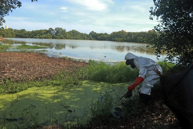 A worker cleans the Romulo Gallegos Lagoon in celebration of Earth Day in Lecheria, Anzoategui state, Venezuela, on April 22, 2026. (Photo by Carlos Kike Landaeta / AFP)