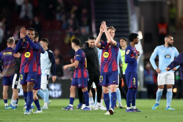 Barcelona's French defender #23 Jules Kounde (L) and Barcelona's Dutch midfielder #21 Frenkie De Jong clap at the end of the Spanish league football match between FC Barcelona and RC Celta de Vigo at Camp Nou stadium in Barcelona on April 22 , 2026. (Photo by Josep LAGO / AFP)