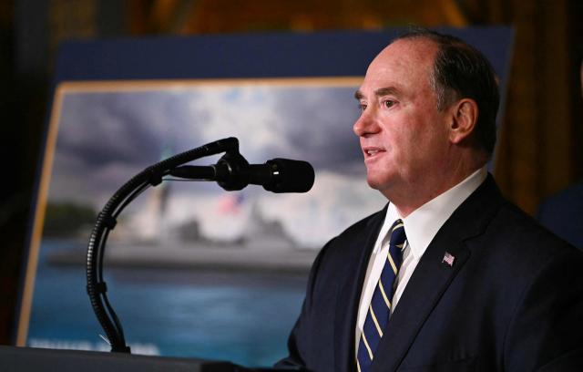(FILES) US Navy Secretary John Phelan speaks about the US Navys new Golden Fleet initiative, unveiling a new class of warships, at Mar-a-Lago in Palm Beach, Florida, on December 22, 2025. Phelan will leave office "immediately," the Pentagon announced on April 22, 2026, without providing an explanation for the sudden exit. Phelan "is departing the administration, effective immediately," Pentagon spokesman Sean Parnell said in a statement on X, adding that he would be replaced in an acting capacity by Undersecretary Hung Cao. (Photo by ANDREW CABALLERO-REYNOLDS / AFP)