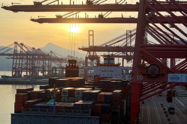 A container ship is seen at the port in Lianyungang, in China’s eastern Jiangsu province early on April 23, 2026. (Photo by CN-STR / AFP) / China OUT