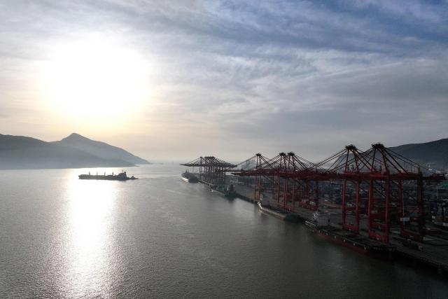 A cargo ship sails beside the port of Lianyungang, in China’s eastern Jiangsu province early on April 23, 2026. (Photo by CN-STR / AFP) / China OUT