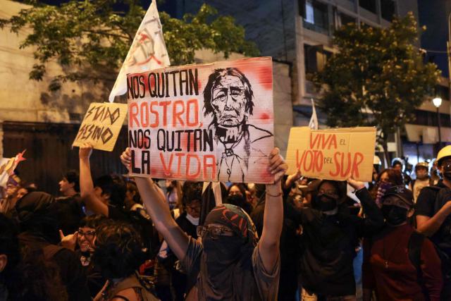 A student holds a sign reading “They take away our identity, they take away our lives” during a protest over transport fares in Lima on April 22, 2026. (Photo by Connie FRANCE / AFP)