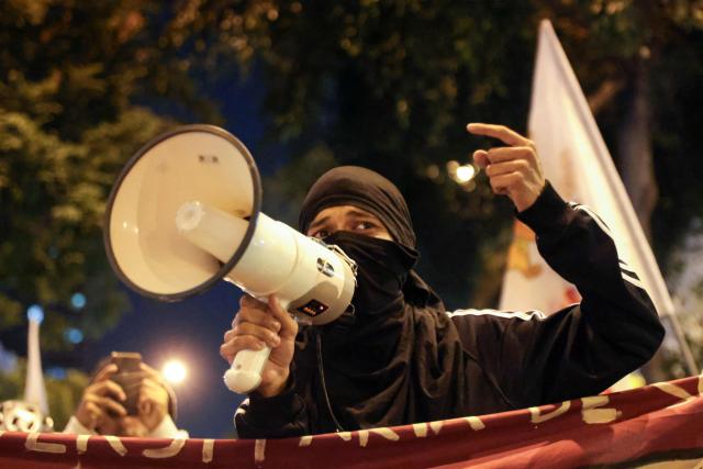 A student shouts slogans through a megaphone during a protest over transport fares in Lima on April 22, 2026. (Photo by Connie FRANCE / AFP)