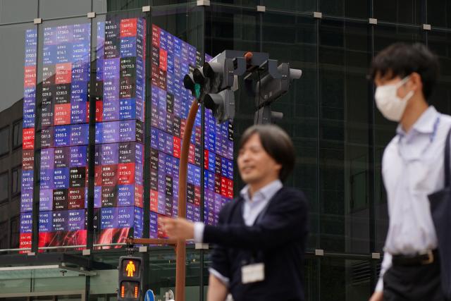 An electronic quotation board displays the Nikkei 225 stock prices on the Tokyo Stock Exchange in Tokyo on April 23, 2026. Japan's Nikkei index soared above 60,000 points for the first time in early trade on April 23, as tech shares attracted buyers, while South Korea's Kospi also reached a new high. (Photo by Kazuhiro NOGI / AFP)