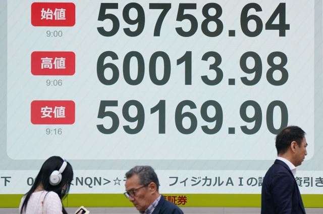 An electronic quotation board displays the Nikkei Stock Average on the Tokyo Stock Exchange (top to bottom) opening price, highest price, and lowest price for this morning, along a street in Tokyo on April 23, 2026. Japan's Nikkei index soared above 60,000 points for the first time in early trade on April 23, as tech shares attracted buyers, while South Korea's Kospi also reached a new high. (Photo by Kazuhiro NOGI / AFP)