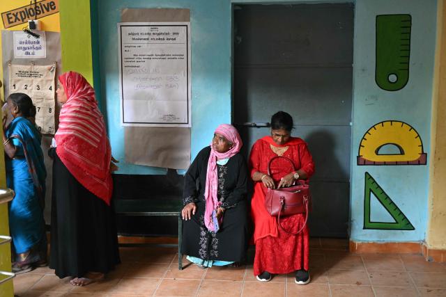 Voters wait to cast their vote outside a polling station during the 2026 Tamil Nadu Legislative Assembly elections in Chennai on April 23, 2026. (Photo by R.Satish BABU / AFP)