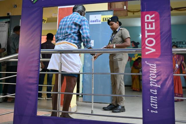 A voter arrives to cast his vote outside a polling station during the 2026 Tamil Nadu Legislative Assembly elections in Chennai on April 23, 2026. (Photo by R.Satish BABU / AFP)