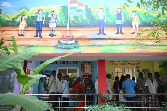 Voters queue to cast their vote outside a polling station during the 2026 Tamil Nadu Legislative Assembly elections in Chennai on April 23, 2026. (Photo by R.Satish BABU / AFP)