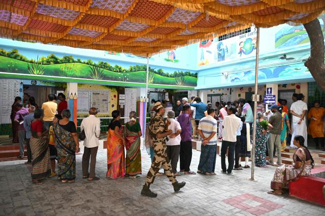 Voters queue to cast their vote outside a polling station during the 2026 Tamil Nadu Legislative Assembly elections in Chennai on April 23, 2026. (Photo by R.Satish BABU / AFP)