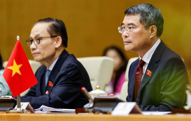 Vietnam's Prime Minister Le Minh Hung (R) sits during a meeting with South Korea's President Lee Jae Myung at the Government Office in Hanoi on April 23, 2026. (Photo by LUONG THAI LINH / POOL / AFP)