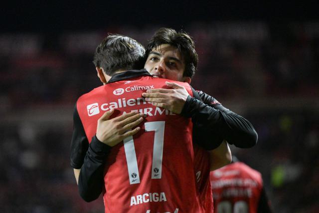 Tijuana's midfielder #19 Gilberto Mora celebrates scoring his team's first goal with forward #17 Ramiro Arcigaduring a Mexican League football match between Tijuana and Pachuca at Caliente stadium in Tijuana, Mexico, on April 22, 2026. (Photo by Guillermo ARIAS / AFP)