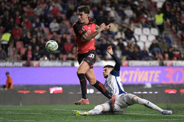 Tijuana's forward #31 Diego Abreu and Pachuca's defender #184 Cristobal Alfaro fight for the ball during a Mexican League football match between Tijuana and Pachuca at Caliente stadium in Tijuana, Mexico, on April 22, 2026. (Photo by Guillermo ARIAS / AFP)