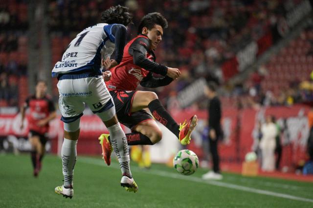 Pachuca's defender #21 Rene Lopez and Tijuana's midfielder #19 Gilberto Mora fight for the ball during a Mexican League football match between Tijuana and Pachuca at Caliente stadium in Tijuana, Mexico, on April 22, 2026. (Photo by Guillermo ARIAS / AFP)