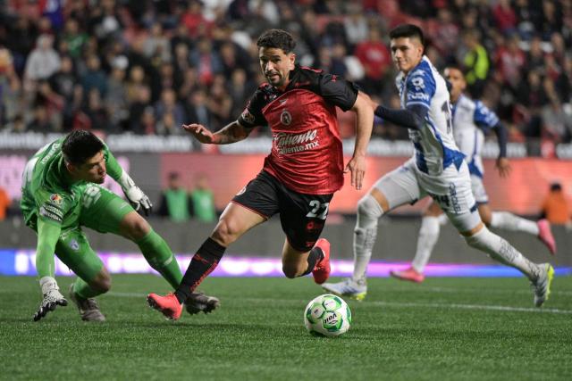 Pachuca's goalkeeper #25 Carlos Moreno and Tijuana's Uruguayan midfielder #22 Ignacio Rivero fight for the ball during a Mexican League football match between Tijuana and Pachuca at Caliente stadium in Tijuana, Mexico, on April 22, 2026. (Photo by Guillermo ARIAS / AFP)