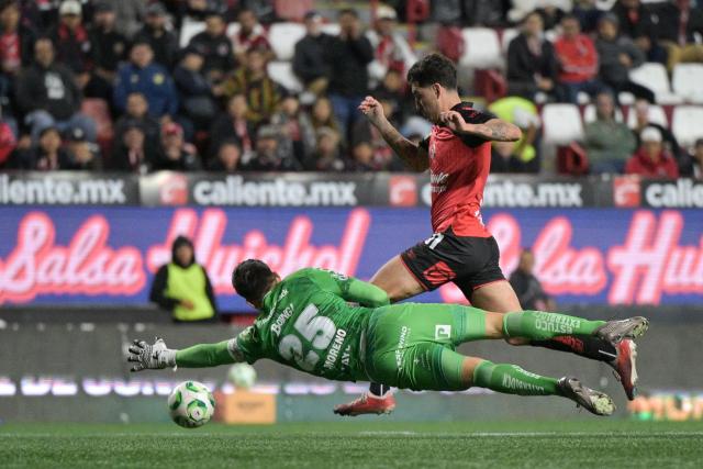 Pachuca's goalkeeper #25 Carlos Moreno and Tijuana's forward #31 Diego Abreu fight for the ball during a Mexican League football match between Tijuana and Pachuca at Caliente stadium in Tijuana, Mexico, on April 22, 2026. (Photo by Guillermo ARIAS / AFP)