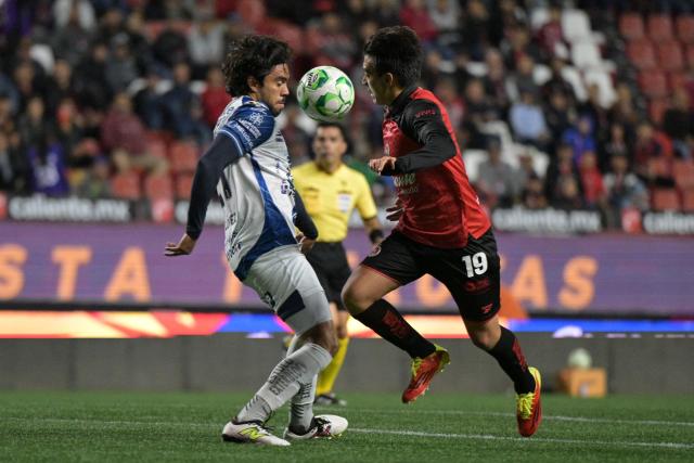 Pachuca's defender #21 Rene Lopez and Tijuana's midfielder #19 Gilberto Mora fight for the ball during a Mexican League football match between Tijuana and Pachuca at Caliente stadium in Tijuana, Mexico, on April 22, 2026. (Photo by Guillermo ARIAS / AFP)