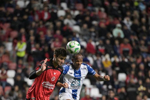 Tijuana's Spanish defender #04 Unai Bilbao and Pachuca's Ecuadorian forward #10 Enner Valencia fight for the ball during a Mexican League football match between Tijuana and Pachuca at Caliente stadium in Tijuana, Mexico, on April 22, 2026. (Photo by Guillermo ARIAS / AFP)
