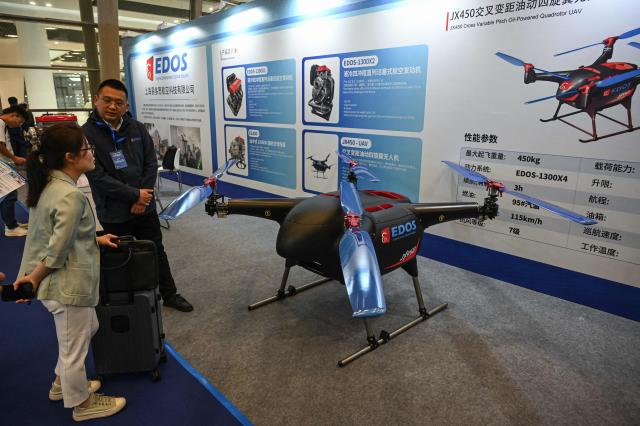 People look at Edos's unmanned aerial vehicle JX450 at the National Defense Technology Industrial Equipment and Information Technology Expo in Shanghai on April 23, 2026. (Photo by Jade GAO / AFP)
