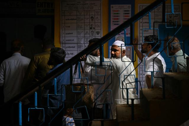 TOPSHOT - Voters queue up to cast their votes at a polling station during the Tamil Nadu Legislative Assembly elections in Chennai on April 23, 2026. Voting began on April 23 in two of India's politically key opposition-held states, with tens of millions casting ballots in West Bengal and the southern Tamil Nadu. (Photo by R.Satish BABU / AFP)