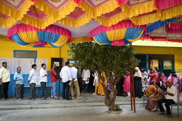 Voters queue up to cast their votes at a polling station during the Tamil Nadu Legislative Assembly elections in Chennai on April 23, 2026. Voting began on April 23 in two of India's politically key opposition-held states, with tens of millions casting ballots in West Bengal and the southern Tamil Nadu. (Photo by R.Satish BABU / AFP)