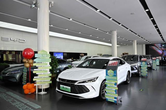 BYD cars are seen on display at a showroom in Beijing on April 23, 2026. (Photo by Adek BERRY / AFP)