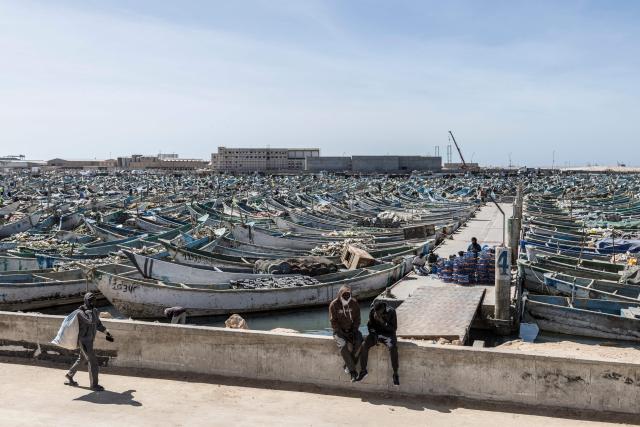 A fisherman walks at the Port Artisanal in Nouadhibou, on April 22, 2026. (Photo by PATRICK MEINHARDT / AFP)