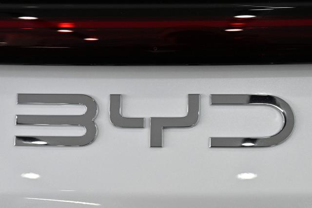 The BYD logo is seen on a vehicle on display at a showroom in Beijing on April 23, 2026. (Photo by Adek BERRY / AFP)