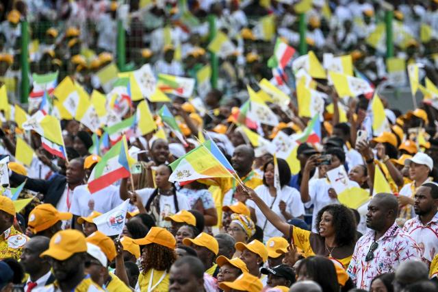 Faithfuls cheer before Pope Leo XIV arrives to lead a Holy Mass at the Malabo Stadium in Malabo on the last day of an 11-day apostolic journey to Africa, on April 23, 2026. (Photo by Alberto PIZZOLI / AFP)