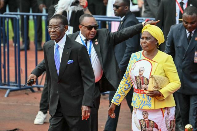 Equatorial Guinea's President Teodoro Obiang Nguema Mbasogo (L) and Equatorial Guinea's First Lady Constancia Mangue (R) arrive ahead of Pope Leo XIV leading a Holy Mass at the Malabo Stadium in Malabo on the last day of an 11-day apostolic journey to Africa, on April 23, 2026. (Photo by Alberto PIZZOLI / AFP)