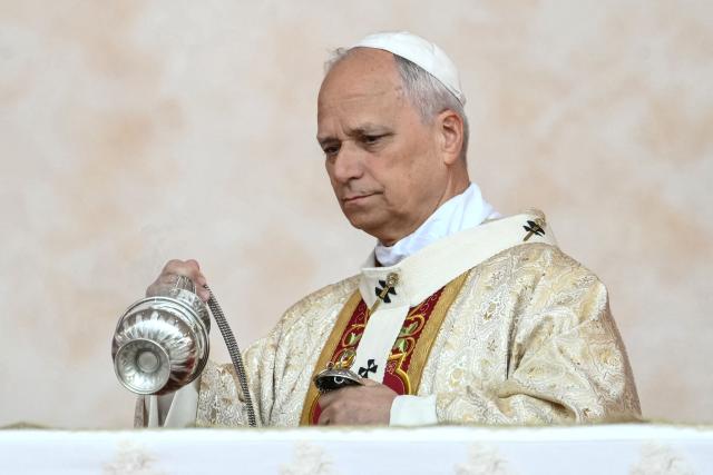 Pope Leo XIV carries the thurible as he leads a Holy Mass at the Malabo Stadium in Malabo on the last day of an 11-day apostolic journey to Africa, on April 23, 2026. (Photo by Alberto PIZZOLI / AFP)