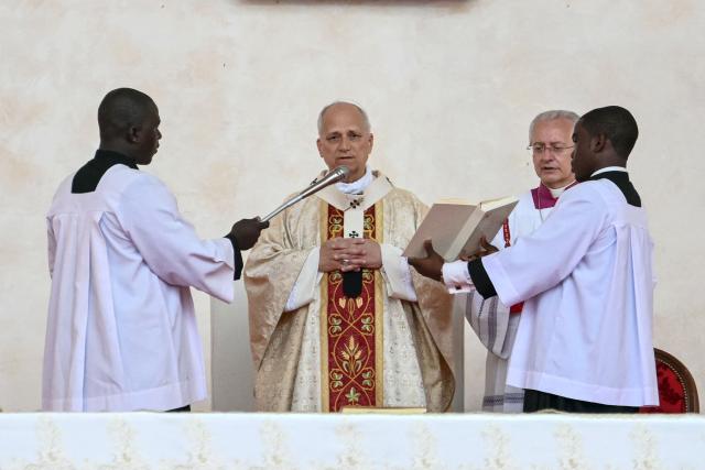 Pope Leo XIV (2nd L) leads a Holy Mass at the Malabo Stadium in Malabo on the last day of an 11-day apostolic journey to Africa, on April 23, 2026. (Photo by Alberto PIZZOLI / AFP)