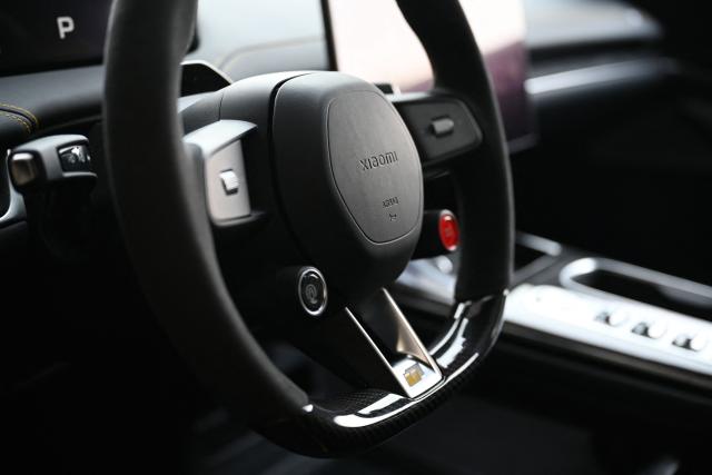The steering wheel of a Xiaomi SU7 Ultra is seen during a Xiaomi track day driving experience in Tianjin, in northern China on April 23, 2026, ahead of the Beijing Auto Show which opens on April 24. (Photo by GREG BAKER / AFP)