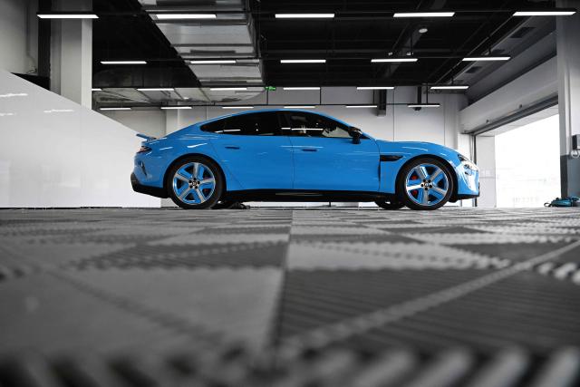 A Xiaomi SU7 Max is seen in a garage during a Xiaomi track day driving experience in Tianjin, in northern China on April 23, 2026, ahead of the Beijing Auto Show which opens on April 24. (Photo by GREG BAKER / AFP)