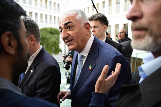 The son of Iran's last shah, exiled Crown Prince Reza Pahlavi speaks to a supporter as he leaves a press conference at the BPK (Bundespressekonferenz) building in Berlin, on April 23, 2026. (Photo by John MACDOUGALL / AFP)