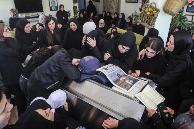 Relatives and friends of Amal Khalil, a veteran correspondent for the daily newspaper Al-Akhbar who was killed in a reported Israeli airstrike in southern Lebanon, mourn at her home in the village of Bisariyeh on April 23, 2026. An Israeli airstrike killed the Lebanese journalist and wounded another on April 22, while they were working near the border with Israel, according to their employer and rescuers. (Photo by MAHMOUD ZAYYAT / AFP)