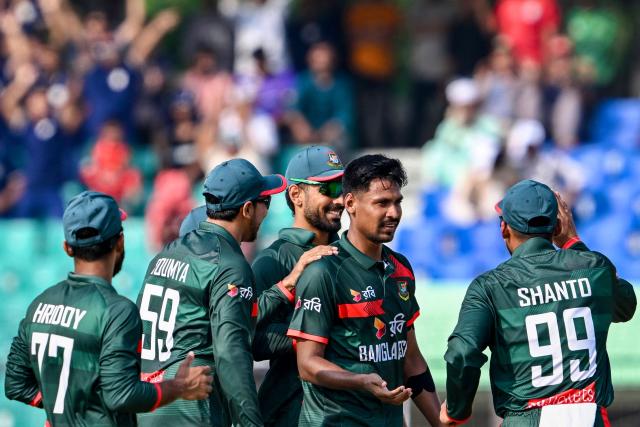 Bangladesh's Mustafizur Rahman (2R) celebrates with teammates after taking the wicket of New Zealand's Henry Nicholls during the third one-day international (ODI) cricket match between Bangladesh and New Zealand at the Bir Sreshtho Flight Lieutenant Matiur Rahman Stadium in Chittagong on April 23, 2026. (Photo by Munir UZ ZAMAN / AFP)
