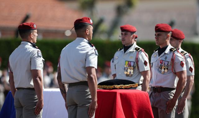 Members of the 17th Parachute Engineer Regiment stand guard by the coffin of late French UNIFIL peacekeeper Sergeant-Major Florian Montorio, killed during an attack against UNIFIL (United Nations Interim Force in Lebanon) in southern Lebanon last weekend, during a tribute ceremony at the military barracks in Montauban, southwestern France, on April 23, 2026. Florian Montorio attached to the 17th Parachute Engineer Regiment in Montauban, in south-western France, was killed during an ambush on UNIFIL peacekeepers on April 18. A second soldier, French Army Staff Sergeant Anicet Girardin, died on April 22 "of the consequences of his wounds" suffered following the weekend ambush. (Photo by Valentine CHAPUIS / AFP)