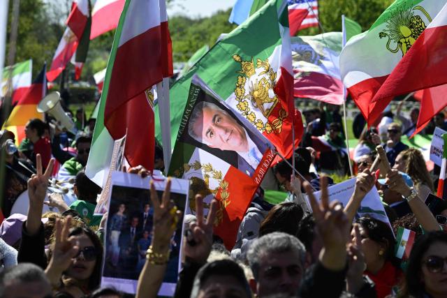 Supporter of son of Iran's last shah, exiled Crown Prince Reza Pahlavi attend a demonstration in Berlin, on April 23, 2026. (Photo by John MACDOUGALL / AFP)