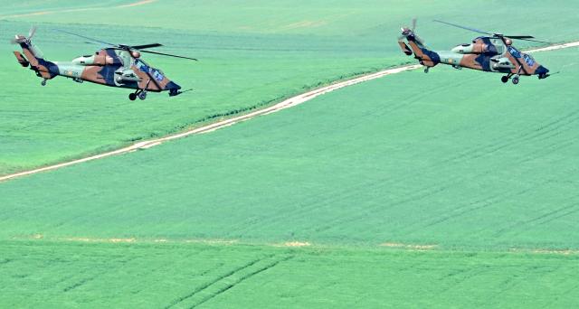 Spanish Army Tigre attack helicopters fly after taking off from Chaumont-Semoutiers airbase during the ORION 26 military drill in Semoutiers-Montsaon, northeastern France, on April 23, 2026. (Photo by Jean-Christophe VERHAEGEN / AFP)