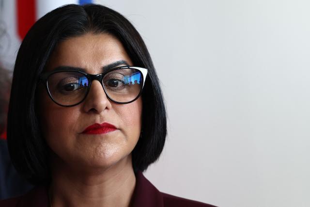 British Home Secretary Shabana Mahmood listens to France's Interior Minister's speech prior to renew the Sandhurst treaty at the Border Police office of Loon-Plage, near Dunkirk, on April 23, 2026. Britain and France have agreed a new three-year deal to stop undocumented migrants making the risky journey across the Channel in small boats, the two sides announced. Under the deal, France pledged to increase law enforcement on the coast by more than half to fight irregular migration to Britain -- reaching 1,400 officers by 2029. The Sandhurst treaty sets out the UK's financial contribution to French efforts to stop migrants attempting the perilous sea crossing to Britain. (Photo by Sameer AL-DOUMY / AFP)