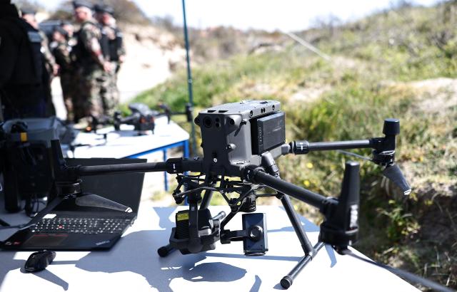 This photograph shows a drone displayed during a presentation of the operational resources used to counter illegal immigration, on the shores of Zuydcoote, near Dunkirk, on April 23, 2026. Britain and France have agreed a new three-year deal to stop undocumented migrants making the risky journey across the Channel in small boats, the two sides announced. Under the deal, France pledged to increase law enforcement on the coast by more than half to fight irregular migration to Britain -- reaching 1,400 officers by 2029. The Sandhurst treaty sets out the UK's financial contribution to French efforts to stop migrants attempting the perilous sea crossing to Britain. (Photo by Sameer AL-DOUMY / AFP)