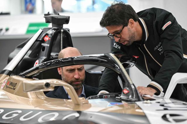 Britain's Prince William (L), Prince of Wales, sits inside a car during a visit to the headquarters of British Formula E team, Jaguar TCS Racing, at Kidlington, Oxfordshire, west of London on April 23, 2026. (Photo by JUSTIN TALLIS / POOL / AFP)