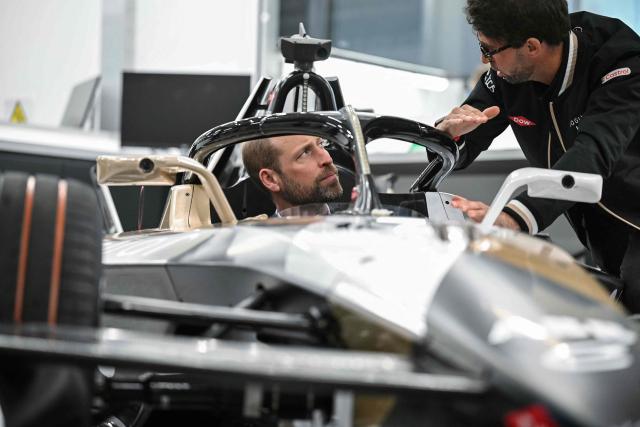Britain's Prince William (L), Prince of Wales, sits inside a car during a visit to the headquarters of British Formula E team, Jaguar TCS Racing, at Kidlington, Oxfordshire, west of London on April 23, 2026. (Photo by JUSTIN TALLIS / POOL / AFP)