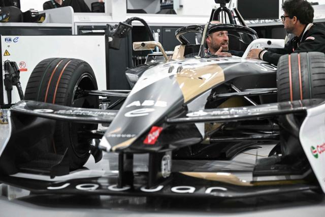 Britain's Prince William (C), Prince of Wales, sits inside a car during a visit to the headquarters of British Formula E team, Jaguar TCS Racing, at Kidlington, Oxfordshire, west of London on April 23, 2026. (Photo by JUSTIN TALLIS / POOL / AFP)