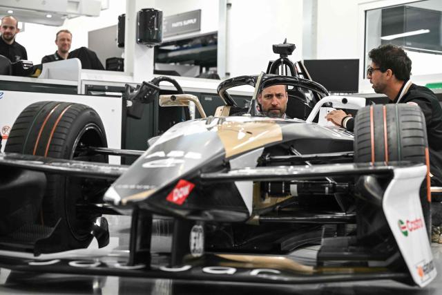 Britain's Prince William (C), Prince of Wales, sits inside a car during a visit to the headquarters of British Formula E team, Jaguar TCS Racing, at Kidlington, Oxfordshire, west of London on April 23, 2026. (Photo by JUSTIN TALLIS / POOL / AFP)