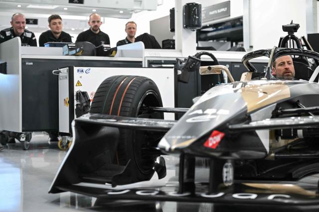 Britain's Prince William (R), Prince of Wales, sits inside a car during a visit to the headquarters of British Formula E team, Jaguar TCS Racing, at Kidlington, Oxfordshire, west of London on April 23, 2026. (Photo by JUSTIN TALLIS / POOL / AFP)