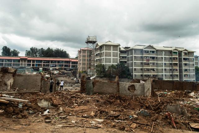Residents of Soweto Zone D clear the remains of demolished structures following government-planned demolitions carried out to make space for a state affordable housing programme at the Kibera informal settlement, in Nairobi on April 23, 2026. Kenyas Affordable Housing Programme is a government initiative to replace informal settlements with low-cost housing. In Kibera, the largest informal settlement in Kenya, demolitions have cleared some areas for new developments aimed at improving living conditions and home ownership. However, the programme has faced controversy over evictions, compensation and displacement of residents before completion of new housing. (Photo by Gordwin Odhiambo / AFP)