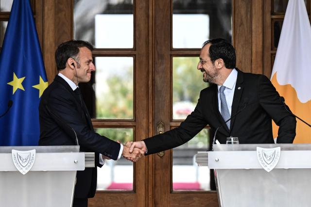 Cyprus’ President Nikos Christodoulides (R) shakes hands with his French counterpart Emmanuel Macron following a meeting at the Presidential Palace in Nicosia on April 23, 2026, on the sidelines of a European summit. (Photo by Jewel SAMAD / AFP)