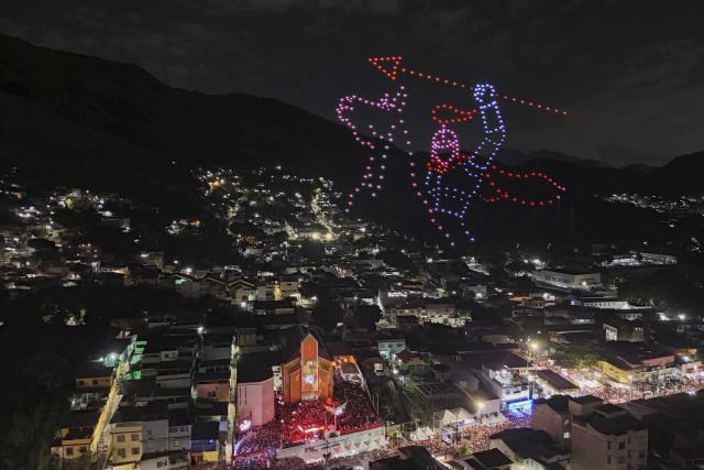The figure of Saint George is recreated with drones next to the church during the Saint George's Day celebrations at the Quintino neighborhood in Rio de Janeiro, Brazil on April 23, 2026. (Photo by Pablo PORCIUNCULA / AFP)